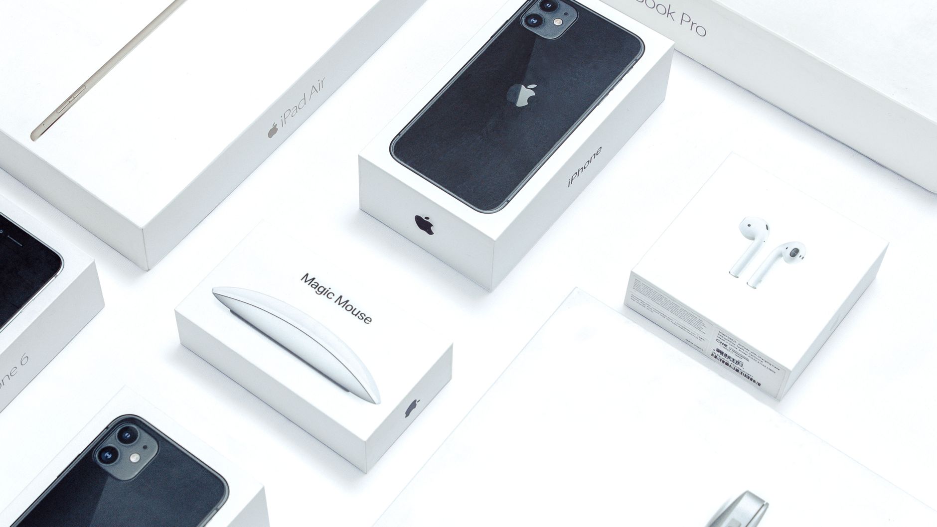 Flat lay of assorted Apple product boxes showcasing technology packaging design.