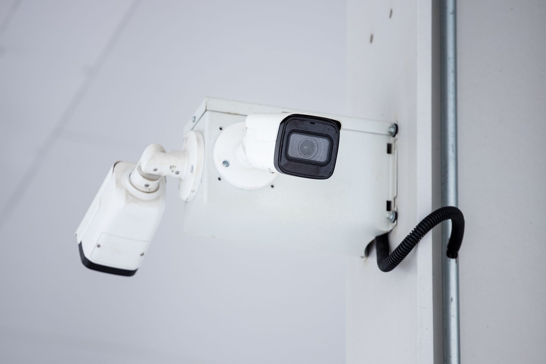 A close-up shot of a modern, mounted surveillance camera highlighting security and surveillance.